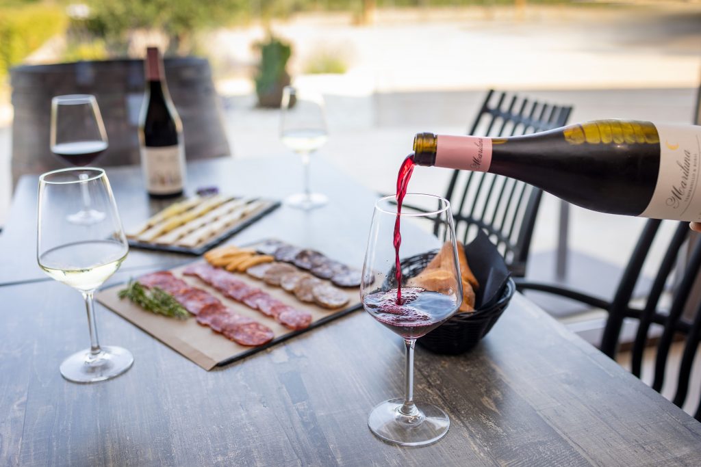 A selection of three Finca Calderón wines paired with artisan cheeses, cured meats, and fresh bread for a complete local gastronomy experience.