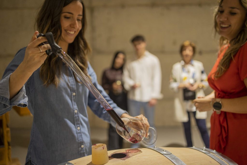 Visitors exploring the bioclimatic ageing cellar at Finca Calderón Enoresort during a guided winery tour and exclusive tasting experience.